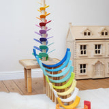 Magic Wood Large Marble Tree Toy, a wooden tall stem with rainbow leaves set up in the Babipur playroom with a Grimm's Gwawr rainbow to create a ball run. 