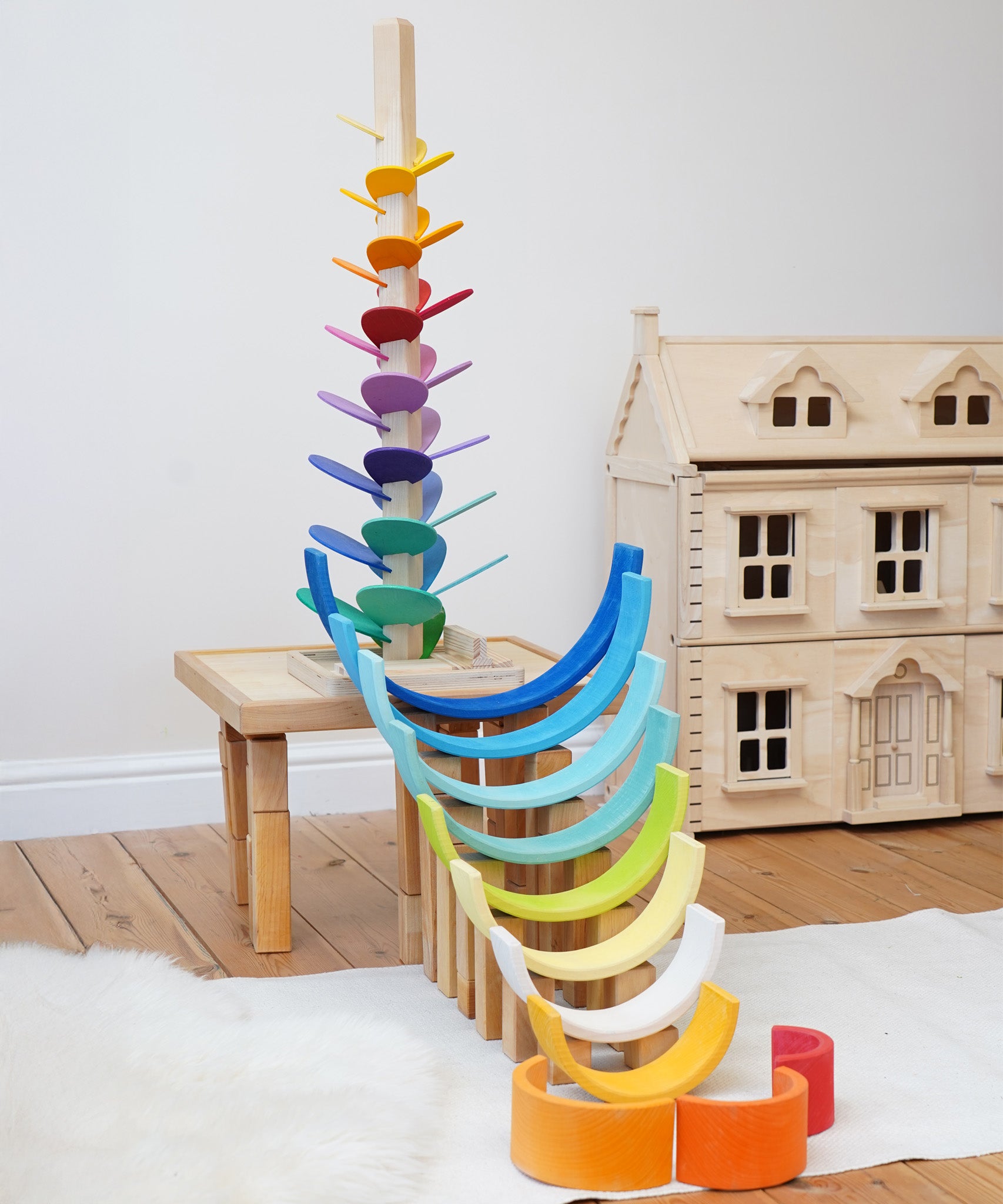 Magic Wood Large Marble Tree Toy, a wooden tall stem with rainbow leaves set up in the Babipur playroom with a Grimm's Gwawr rainbow to create a ball run. 