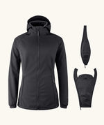 Mamalila soft shell baby wearing allrounder fitted jacket in black next to the 2 inserts included with the jacket