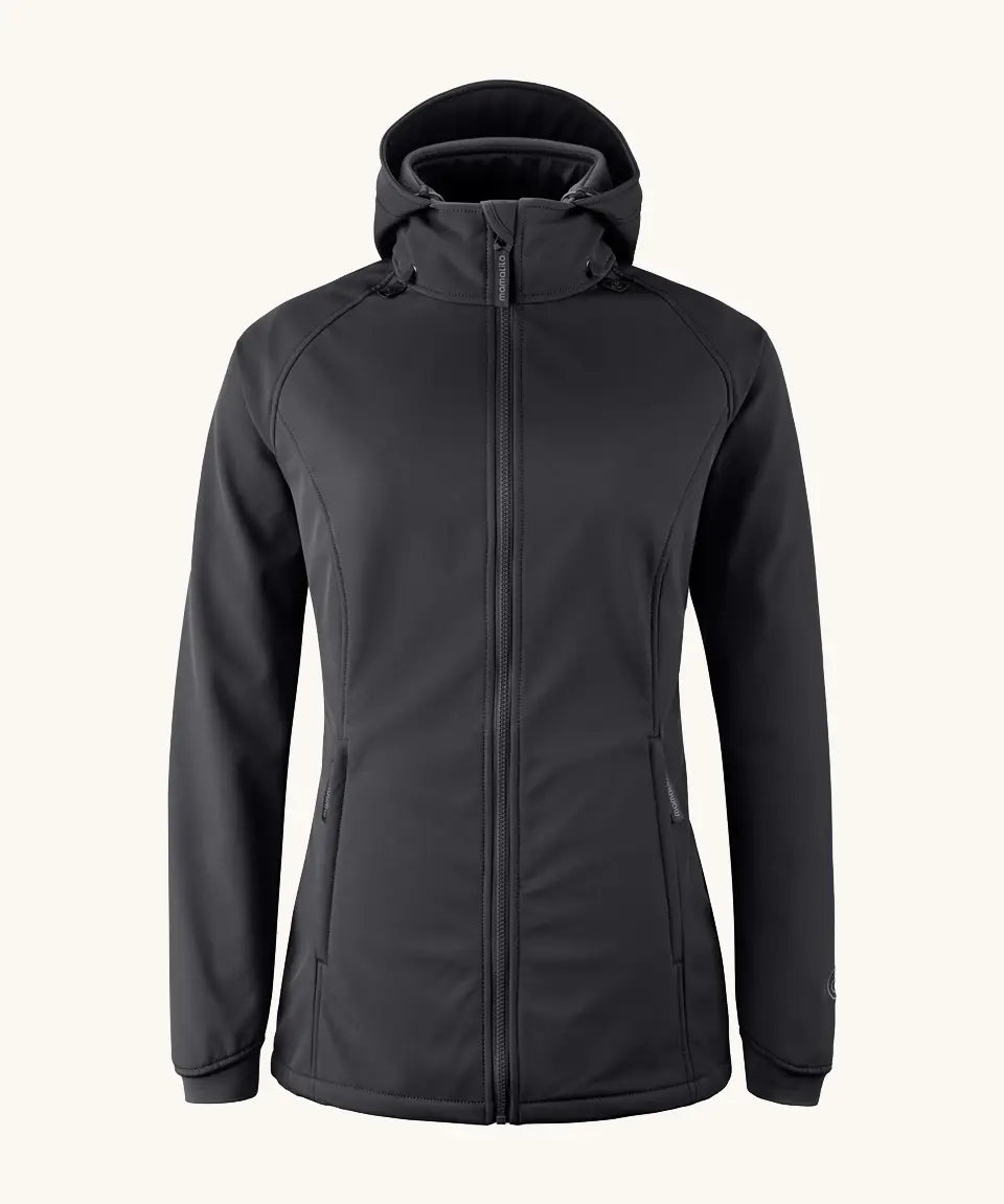 Mamalila soft shell baby wearing allrounder fitted jacket in black. This jacket features a hood, full length front zip and side pockets.