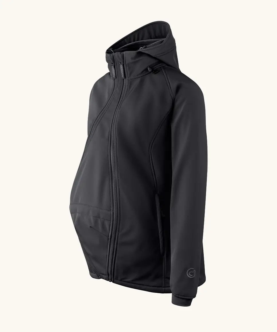 Side of Mamalila soft shell baby wearing allrounder fitted jacket in black. Showing additional panel on front