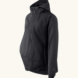 Side of Mamalila soft shell baby wearing allrounder fitted jacket in black. Showing additional panel on front