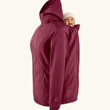 Mamalila soft shell baby wearing allrounder fitted jacket in burgundy showing a baby doll sitting on the back with the protective hood down