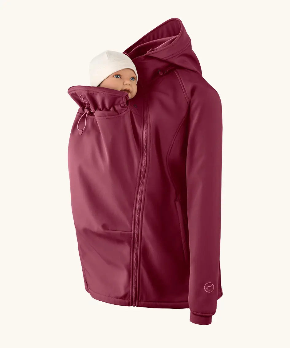 Mamalila soft shell baby wearing allrounder fitted jacket in burgundy showing baby doll demonstrating the forward sitting position 