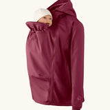 Mamalila soft shell baby wearing allrounder fitted jacket in burgundy showing baby doll demonstrating the forward sitting position 