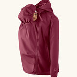 Mamalila soft shell baby wearing allrounder fitted jacket in burgundy showing a baby doll with the protective hood covering the head