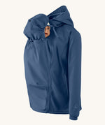 Mamalila soft shell baby wearing allrounder fitted jacket in navy available at Babipur with a baby doll demonstrating the forward sitting position with the protective hood covering the baby doll