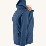 Mamalila soft shell baby wearing allrounder fitted jacket in navy available at Babipur showing a baby doll sitting on the back with the protective hood down
