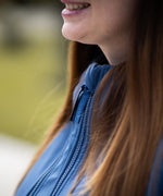A close up of a mother wearing the Mamalila soft shell baby wearing allrounder fitted jacket in navy available at Babipur showing the zip detail