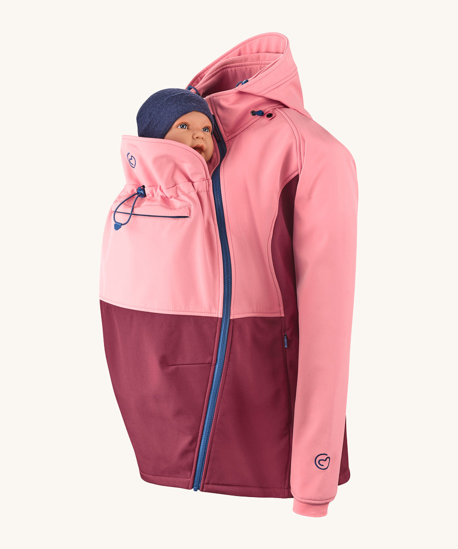 Mamalila soft shell baby wearing allrounder limited edition pro jacket in party purple available at Babipur with a baby doll demonstrating the forward sitting position with the protective hood down