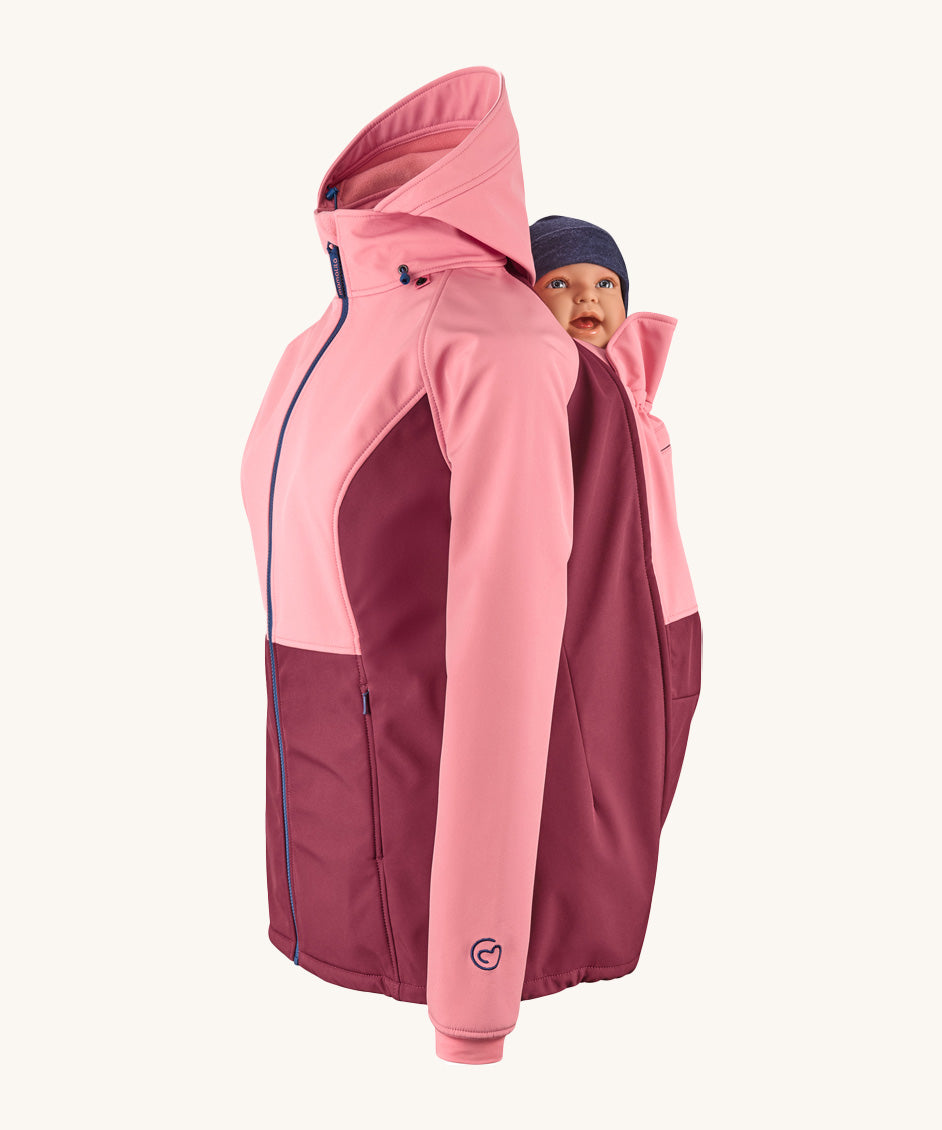 Mamalila soft shell baby wearing allrounder limited edition pro jacket in party purple available at Babipur showing a baby doll sitting on the back with the protective hood down