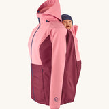 Mamalila soft shell baby wearing allrounder limited edition pro jacket in party purple available at Babipur showing a baby doll sitting on the back with the protective hood down