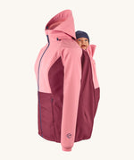 Mamalila soft shell baby wearing allrounder limited edition pro jacket in party purple available at Babipur showing a baby doll sitting on the back with the protective hood down