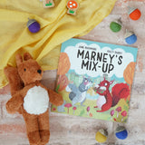 Marney's Mix Up Autumnal children's book by Jane Rushmore and illustrator Sally Darby, a book about squirrels collecting acorns, with Papoose felt acorns and a Senger baby squirrel.