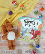 Marney's Mix Up Autumnal children's book by Jane Rushmore and illustrator Sally Darby, a book about squirrels collecting acorns, with Papoose felt acorns and a Senger baby squirrel.