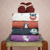 Stack of Maxomorra kids long sleeve tops with Little Green Radicals knitted booties on top.