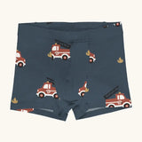 Maxomorra kids GOTS organic cotton boxer shorts in navy with a repeating cartoon style fire truck print. Features an elasticated waist band