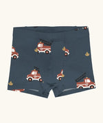 Maxomorra kids GOTS organic cotton boxer shorts in navy with a repeating cartoon style fire truck print. Features an elasticated waist band