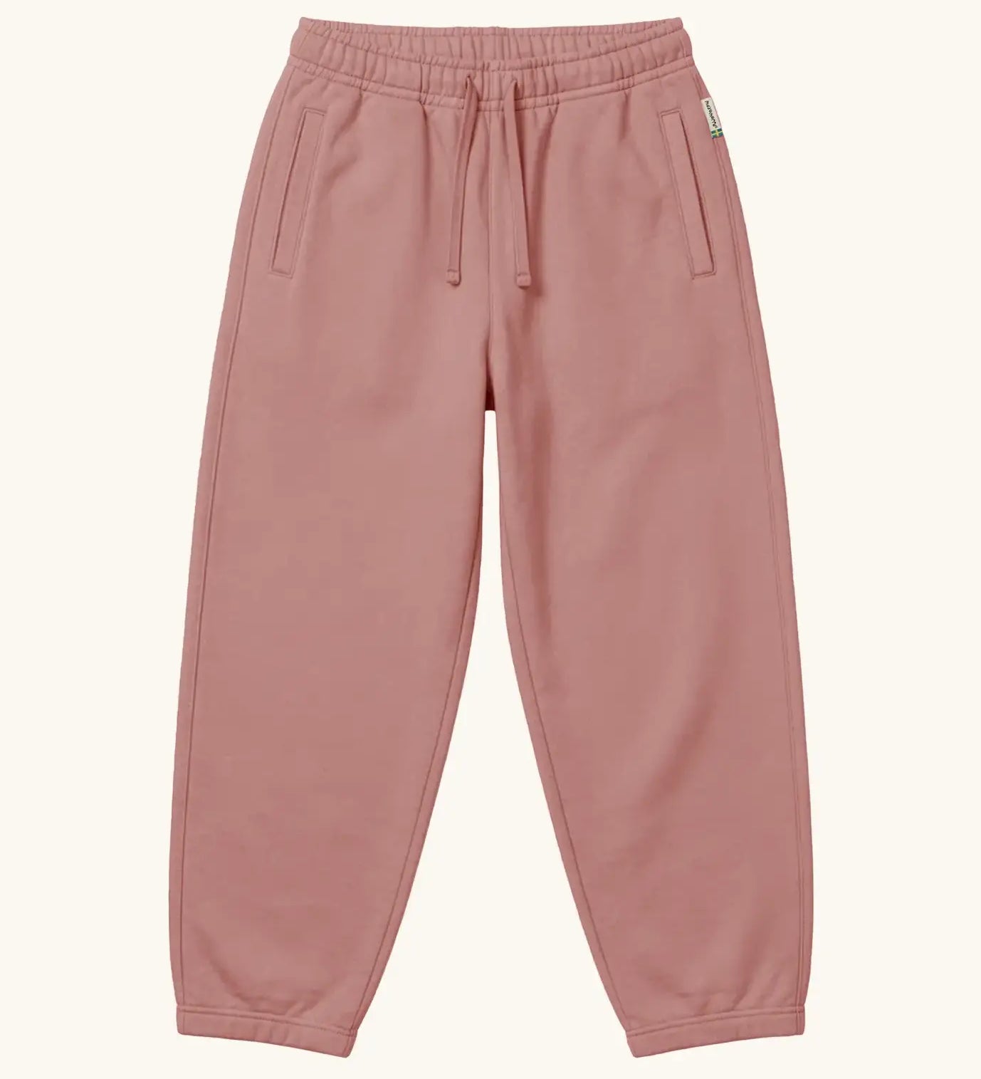 Maxomorra kids baggy sweat pants in solid pink, features a drawstring cord around the waist and side pockets