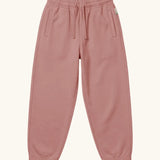 Maxomorra kids baggy sweat pants in solid pink, features a drawstring cord around the waist and side pockets
