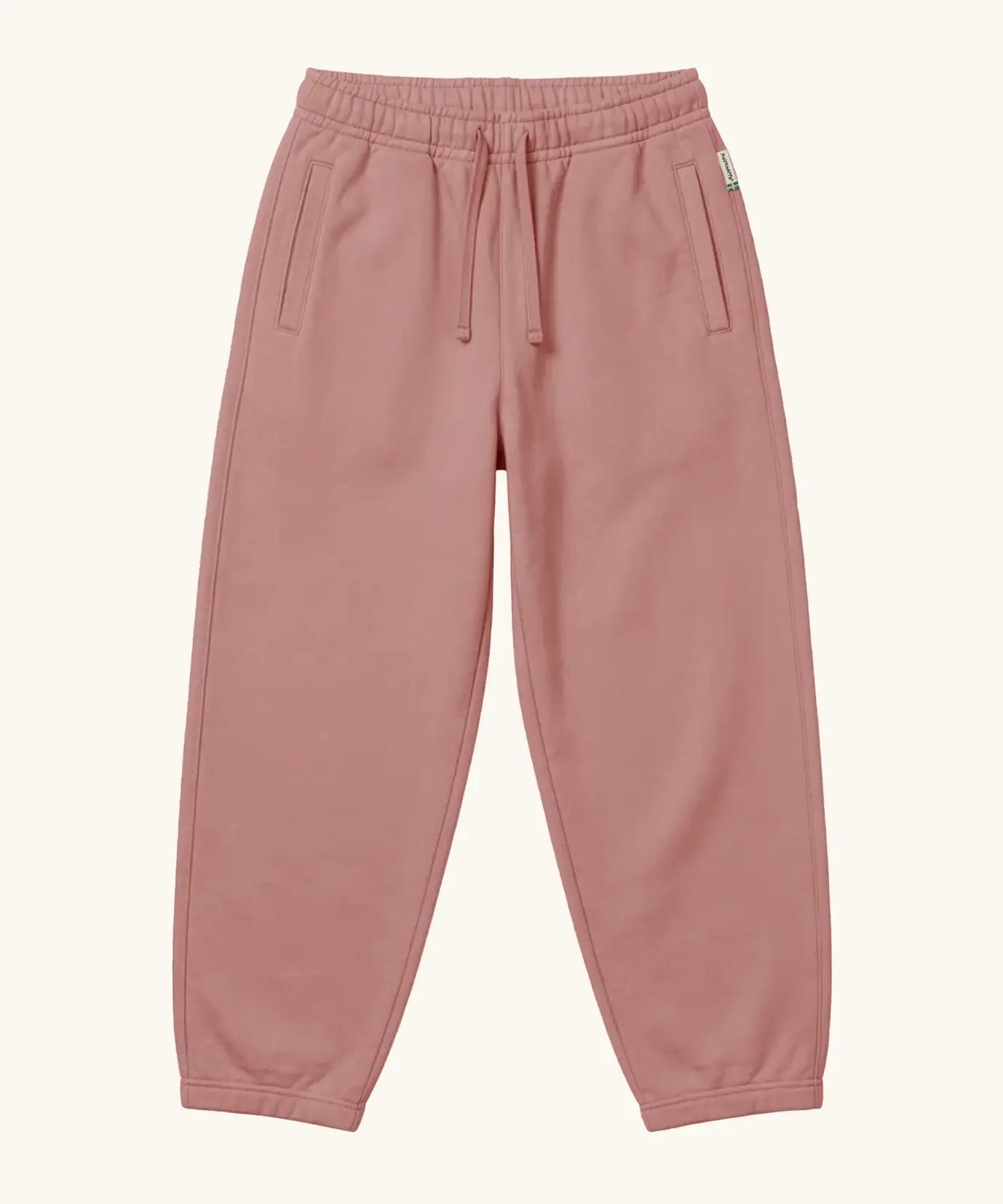Maxomorra kids baggy sweat pants in solid pink, features a drawstring cord around the waist and side pockets