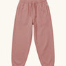 Maxomorra kids baggy sweat pants in solid pink, features a drawstring cord around the waist and side pockets