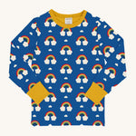 Maxomorra Rainbow Long Sleeved Children's Top is blue with a repeat rainbow print, and contrasting yellow elasticated cuffs and neck trim 
