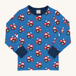 Maxomorra Organic Cotton Tractor Long Sleeved Children's Top is blue with a repeat red tractor print, and contrasting navy elasticated cuffs and neck trim