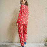 A woman wearing a Maxomorra Swedish Santa Adult Long Sleeve Pyjama Set standing in front of a beige coloured wall. The woman is facing away from the camera showing teh back of the pyjamas. 