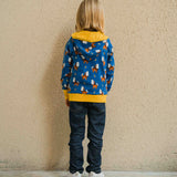 A child wearing a Maxomorra Wolf Reversible Zip Hoodie. The child is facing away from the camera showing the back of the hoodie. 