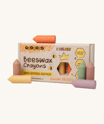 Medenka junior pastel beeswax crayons standing next to their cardboard box packaging.