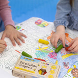 A closeup of children using the Medenka natural beeswax crayons to colour in an ocean drawing. 