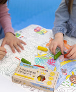 A closeup of children using the Medenka natural beeswax crayons to colour in an ocean drawing. 