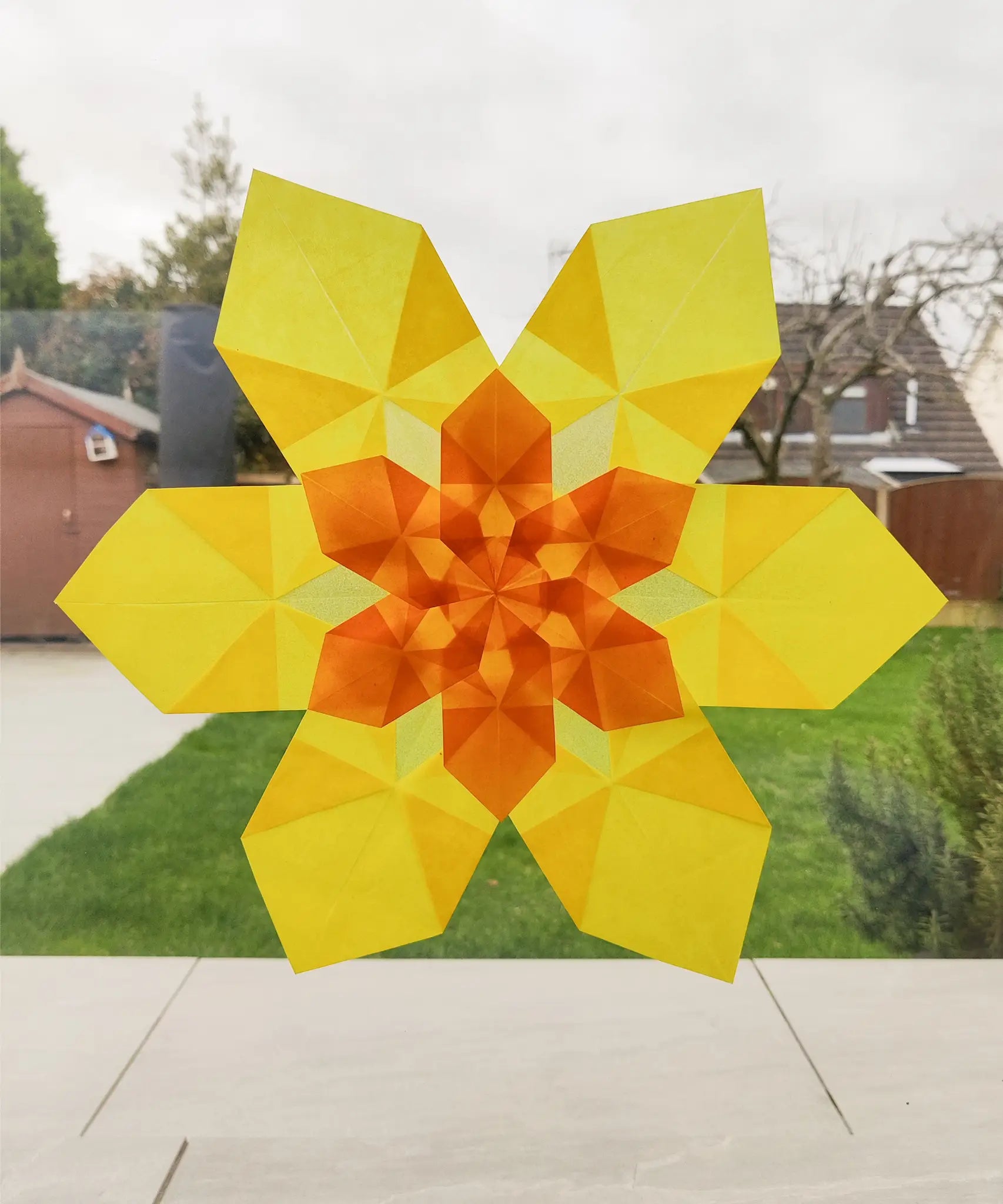Window display showing a yellow daffodil made from Kite waxed paper