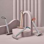 A collection of four MÜHLE Companion Safety Razors on a light pink display and background