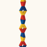 Naef Vivo, a set of V-shaped wooden pieces in yellow, blue and red by Japanese toy designer Yasuo Aizawa, designed for open-ended construction and creative play.