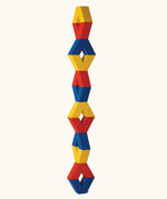 Naef Vivo, a set of V-shaped wooden pieces in yellow, blue and red by Japanese toy designer Yasuo Aizawa, designed for open-ended construction and creative play.