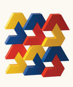 Naef Vivo, a sleek construction toy made up of V-shaped wooden pieces in yellow, blue and red, created by renowned Japanese toy designer Yasuo Aizawa.
