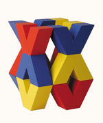 Naef Vivo, a colourful construction toy featuring V-shaped wooden pieces in yellow, blue and red, designed by Japanese toy designer Yasuo Aizawa.