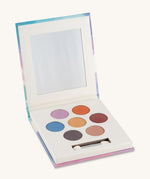An open Namaki Natural Eyeshadow Pallet - Owl, showing the colours which are pink, orange, maroon, gold, blue, purple and peach on a cream background