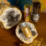 The  Namaki Gold Fox Sparkling Pouch make up on a wooden table with a crystal geode