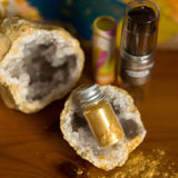 The  Namaki Gold Fox Sparkling Pouch make up on a wooden table with a crystal geode