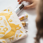A child taking out the make up from the Namaki Gold Fox Sparkling Pouch