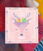 The Namaki Natural Eyeshadow Pallet - Fawn on top of a colourful blanket