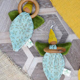 Pair of Nanchen flower fairies, an organic cotton floral grasping baby toy with a wooden ring, green velour wings and yellow pointed hat and a loop for hanging, for sale at Babipur.