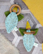 Pair of Nanchen flower fairies, an organic cotton floral grasping baby toy with a wooden ring, green velour wings and yellow pointed hat and a loop for hanging, for sale at Babipur.