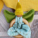 Nanchen organic cotton flower fairy baby toy featuring wooden grasping ring, soft green velour wings, yellow pointed hat, and loops for hanging, sold at Babipur.