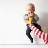 Adult holding a baby that's playing with the Nanchen ice cream rattle doll 