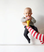 Adult holding a baby that's playing with the Nanchen ice cream rattle doll 
