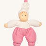 Nanchen Möpschen Doll - Pink. A soft and cuddly doll with pink trousers, a white top and white hat with a pink bobble on top